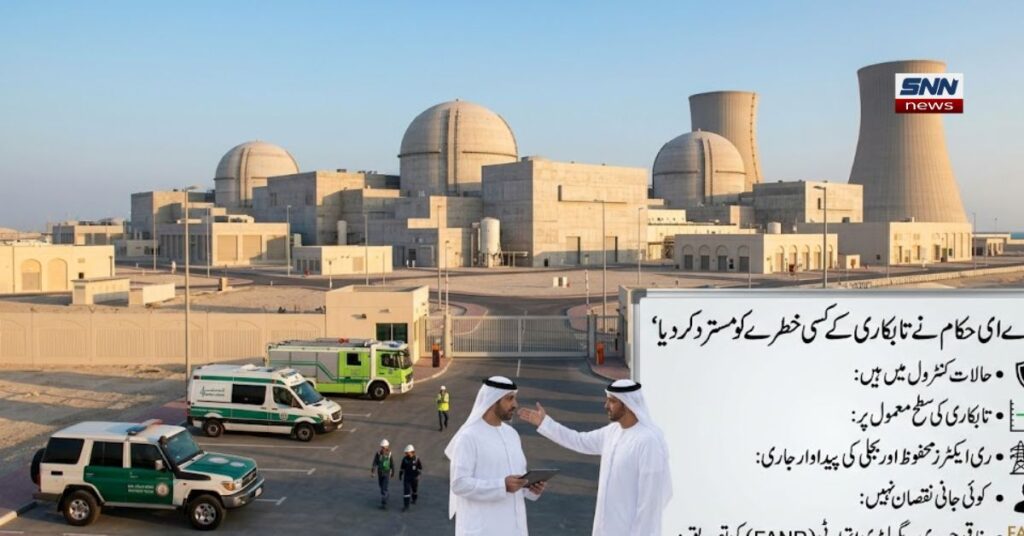 آلٹ ٹیکسٹ (Alt Text): متحدہ عرب امارات (UAE) کے ایک جدید نیوکلیئر پاور پلانٹ (جیسے براکہ نیوکلیئر پلانٹ) کا بیرونی اور پرامن منظر۔ تصویر میں بڑے کولنگ ٹاورز اور کنکریٹ کے بنے گنبد نما ری ایکٹر یونٹس واضح نظر آ رہے ہیں، جہاں کوئی دھواں یا آگ کا نام و نشان موجود نہیں ہے۔ پلانٹ کے داخلی راستے کے باہر اماراتی لباس (کندورہ اور غترہ) پہنے دو اعلیٰ حکام آپس میں گفتگو کر رہے ہیں اور صورتحال کا جائزہ لے رہے ہیں۔ ایمرجنسی گاڑیوں کے پارکنگ ایریا میں سول ڈیفنس کی ایک فائر بریگیڈ گاڑی، ایمبولینس اور سکیورٹی پٹرولنگ کار موجود ہیں جو الرٹ کھڑی ہیں۔ سامنے دائیں جانب ایک بڑا معلوماتی بورڈ (انفوگرافک پینل) نصب ہے جس پر اردو اور انگریزی متن میں لکھا ہے کہ "یو اے ای حکام نے تابکاری کے کسی بھی خطرے کو مسترد کر دیا" اور وفاقی جوہری ریگولیٹری اتھارٹی (FANR) کی تصدیق کے ساتھ اہم نکات (حالات کنٹرول میں ہیں، تابکاری کی سطح معمول پر ہے، کوئی جانی نقصان نہیں ہوا) درج ہیں۔